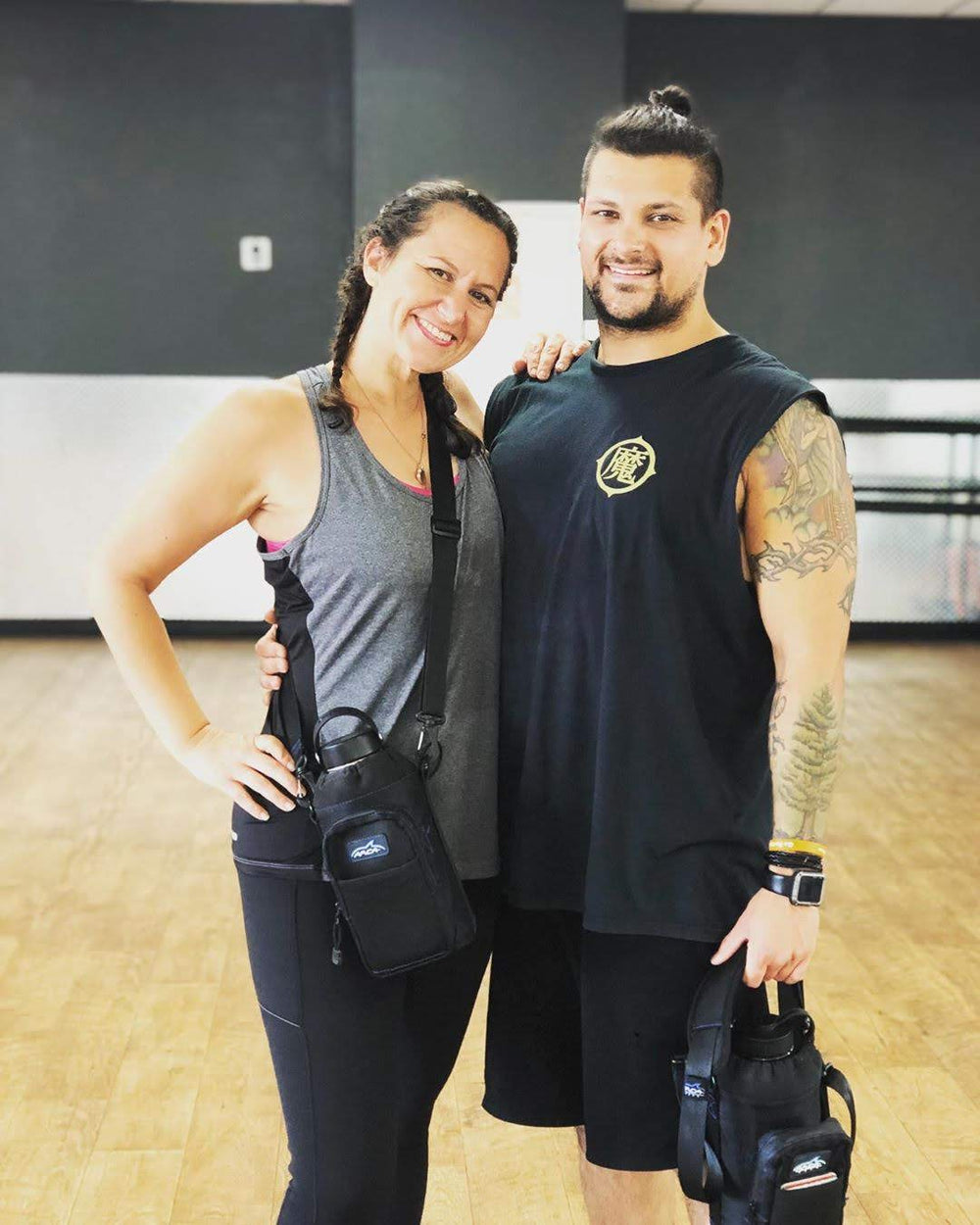 Couple at the gym, each with an Arca Gear Hydro Carrier