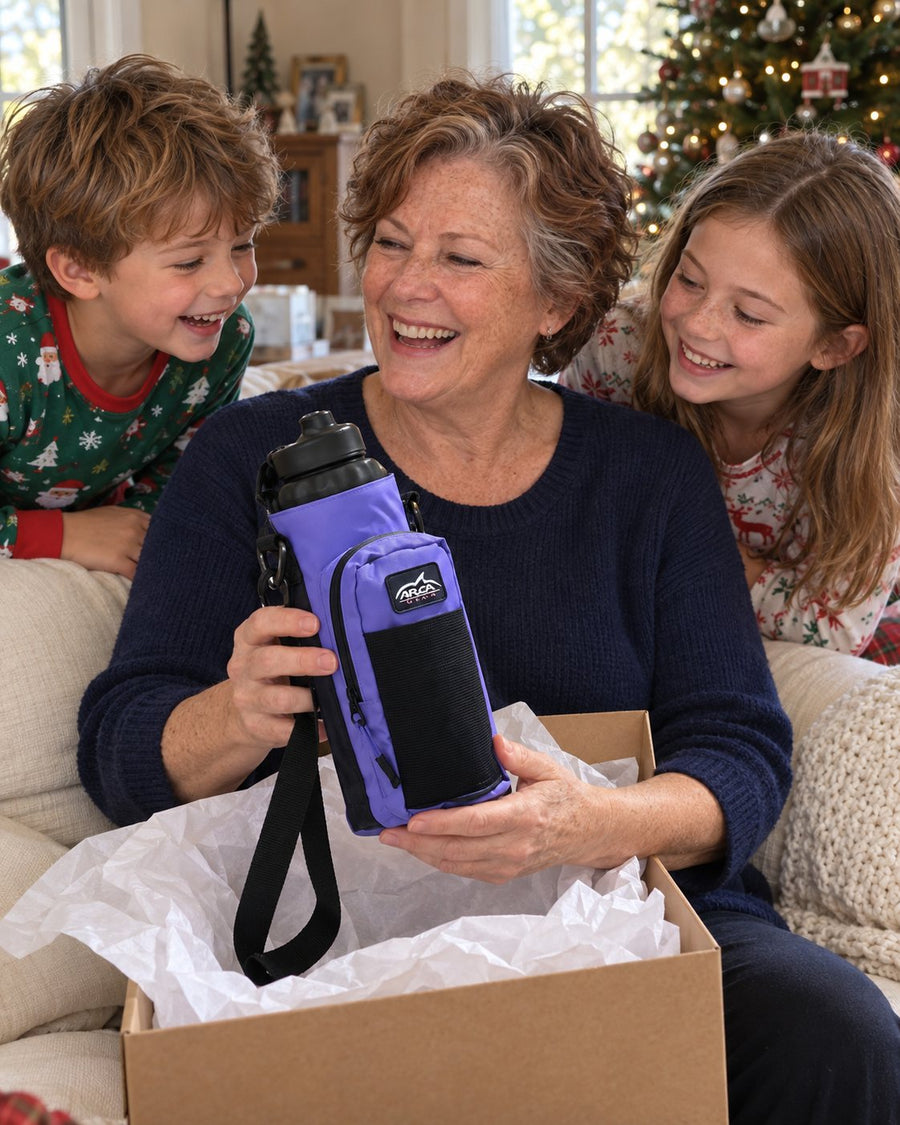 Grandmother opening a lavender Hydro Carrier with her grandkids on Christmas morning
