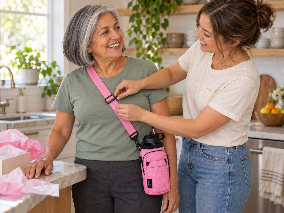 Daughter adjusting the strap of a pink Hydro Carrier for her mom